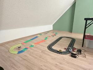 a toy race track on the floor of a room at Das kleine Vulkanhaus in Daun +41 photos