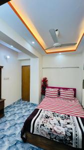 a bedroom with a large bed with red pillows at Hotel Prime City Residential in Dhaka
