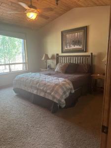 a bedroom with a bed and a large window at Torreon Getaway on the Greens with hot tub, 4 bedrooms, sleeps 10 in Show Low