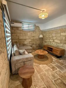 a living room with a couch and a table at 'I Elea' Village House with Courtyard in Letimbou +37 photos