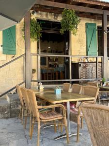 a wooden table and chairs on a patio at 'I Elea' Village House with Courtyard in Letimbou