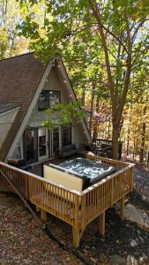 a large deck with a hot tub on a house at Apple Mountain Retreat at Shenandoah National Park 