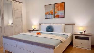 a bedroom with a large bed with two night stands at Premium Stay - Spacious 3BR with Balcony in Bucharest