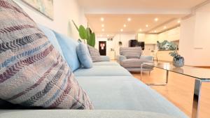 a living room with a couch and a glass table at Premium Stay - Spacious 3BR with Balcony in Bucharest +41 photos