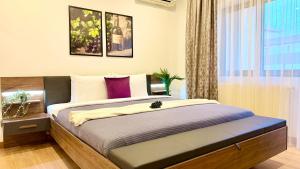a bedroom with a bed and a window at Premium Stay - Spacious 3BR with Balcony in Bucharest