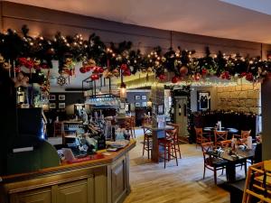 a restaurant with tables and chairs and christmas decorations at The Graeme Hotel in Falkirk
