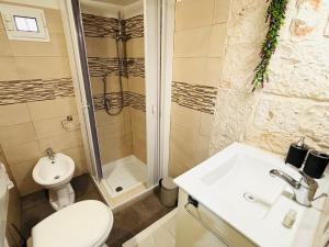 a bathroom with a toilet and a sink and a shower at Gasparro House in Turi