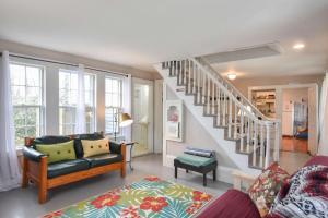 a living room with a couch and a staircase at Walk to Restaurants Shopping & Harbor in Wellfleet