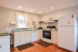 a kitchen with white appliances and a white refrigerator at Walk to Restaurants Shopping & Harbor in Wellfleet