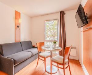 Et opholdsområde på Séjours & Affaires Nantes La Beaujoire