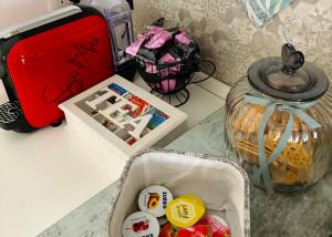 a table with a suitcase and a container of candy at Gasparro House in Turi