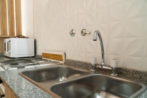 a kitchen with a sink and a stove at Grin Apartments in San Rafael +71 photos