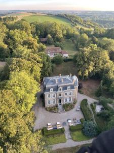 an aerial view of a large house in the woods at Domaine des Monts de la Baie in Mareuil-Caubert