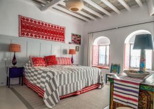 a bedroom with a bed with red pillows at Xinara House in Tripótamos