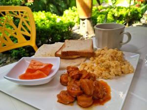 Hostal Capurgana في كابورغانا: صحن من الطعام به لحم وخبز وكوب من القهوة