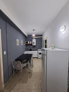 a kitchen with a table and a refrigerator at Nami in Necochea