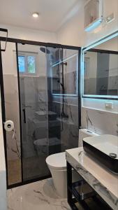 un bagno con doccia, WC e lavandino di Edades Farms a Taysan