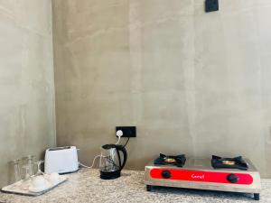 a kitchen with a red and white stove on a counter at Bella Nova in Ahangama