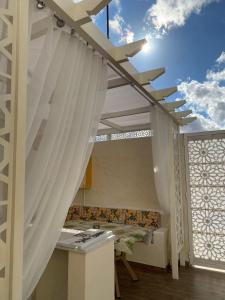 a kitchen with a white ceiling and a window at Villa Sabrina in Awlād ‘Umar