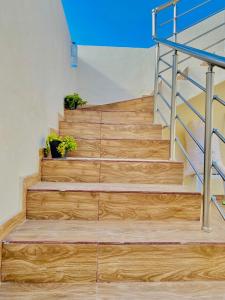 a set of wooden stairs with a metal railing at Villa Sabrina in Awlād ‘Umar +14 photos