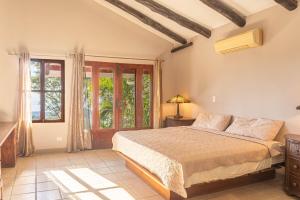 a bedroom with a bed and a window at Casa Nubes - Ocean View in Carrillo +79 photos