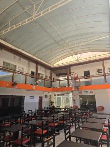 a room with tables and chairs in a building at Hotel Itu Shopping in Itu