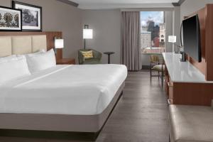 a hotel room with a large bed and a window at DoubleTree by Hilton New Orleans in New Orleans