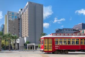 a red trolley car parked in front of a building at DoubleTree by Hilton New Orleans in New Orleans