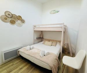 a bedroom with a bunk bed and a chair at Studio Spa Du Bassin in Le Teich
