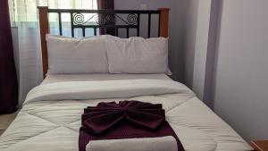 Postel nebo postele na pokoji v ubytování Kilimanjaro Helichrysum Homes