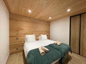 En eller flere senge i et værelse på Appartement Marmotte