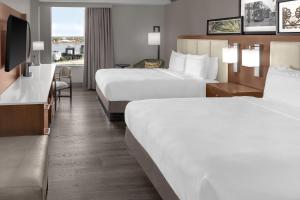 a hotel room with two beds and a television at DoubleTree by Hilton New Orleans in New Orleans