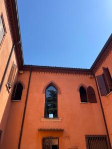 an orange building with a window and a blue sky at Storico appartamento con parco in Sanguinetto