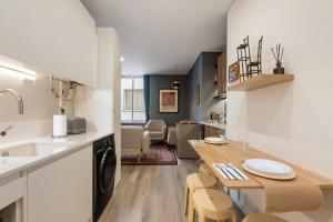 a kitchen and living room with a table and chairs at Boutique in Funchal