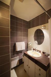 a bathroom with a sink and a mirror at Best Western Grand Hotel de Paris & Spa in Villard-de-Lans