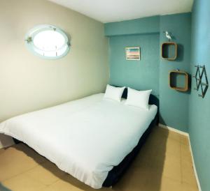 Ένα ή περισσότερα κρεβάτια σε δωμάτιο στο Marines et Salorges - Les Gîtes de la Côte d'Amour