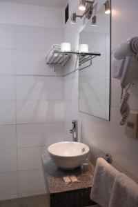 a bathroom with a sink and a mirror at Hotel Centenario in Atlántida
