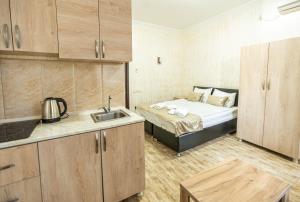 a kitchen with a bed and a sink in a room at Batumi Inn Hotel in Batumi +94 photos