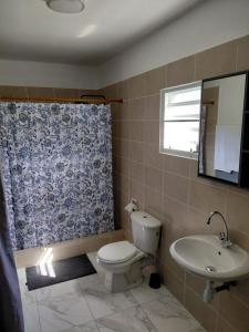 a bathroom with a toilet and a sink at Ecofriendly Apartment in Gated Residence in Saint Martin +5 photos