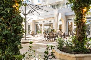 a patio with tables and chairs in a building at Hotel Beit Shmuel in Jerusalem