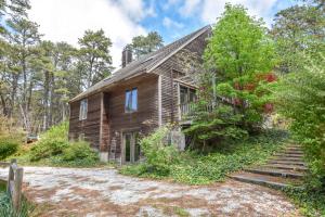 an old wooden house with stairs leading up to it at 15 Min Walk to Beach w Kayaks in Wellfleet