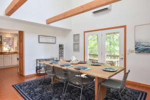 a dining room with a large wooden table and chairs at 15 Min Walk to Beach w Kayaks in Wellfleet +29 photos