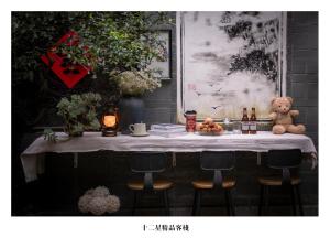 a table with a teddy bear sitting on top of it at 十二星客栈 in Lijiang