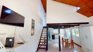 a room with a staircase leading to a kitchen and a dining room at Casa Tipo Loft- Tigre Centro Con Jardin, Parrilla - 4 Personas in Tigre