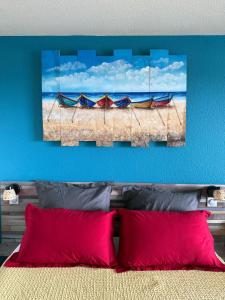 a bedroom with a bed with two boats on the beach at La Kaz a lò in Le Diamant +19 photos