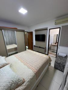 En eller flere senge i et værelse på Casa Recanto de Guarajuba