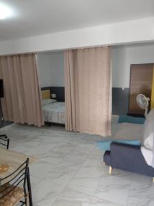 a living room with a couch and a bed at Ecofriendly Apartment in Gated Residence in Saint Martin
