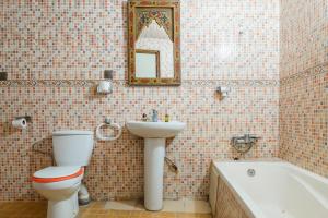 a bathroom with a toilet and a sink and a bath tub at Dar Merzouga Meknes in Meknès +104 photos