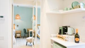 a room with white walls and a room with a table at Palazzo Cettina Sul Mare in Cefalù