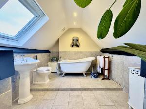 een badkamer met een plafond met een dakraam bij The Corner House in Shipston on Stour